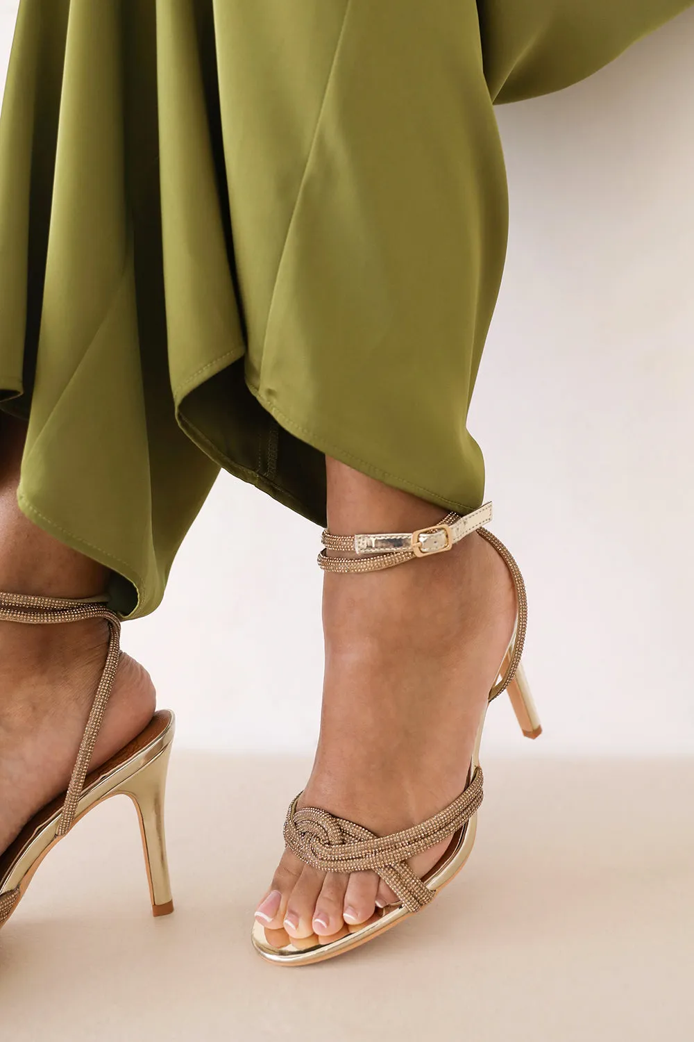 MADON DIAMANTE KNOT DETAIL WITH CROSS OVER ANKLE STRAP HIGH HEELS IN GOLD CHROME